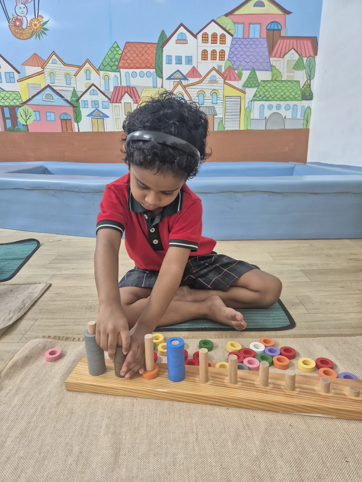 Child exploring colourful learning materials