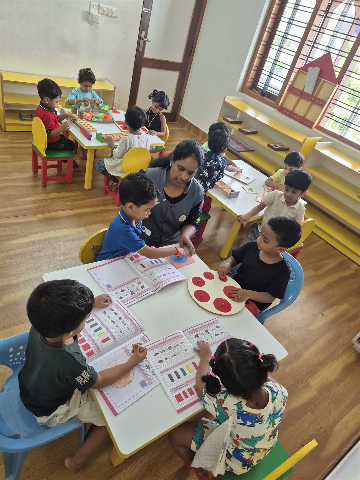 Children working together on an activity at a shared table