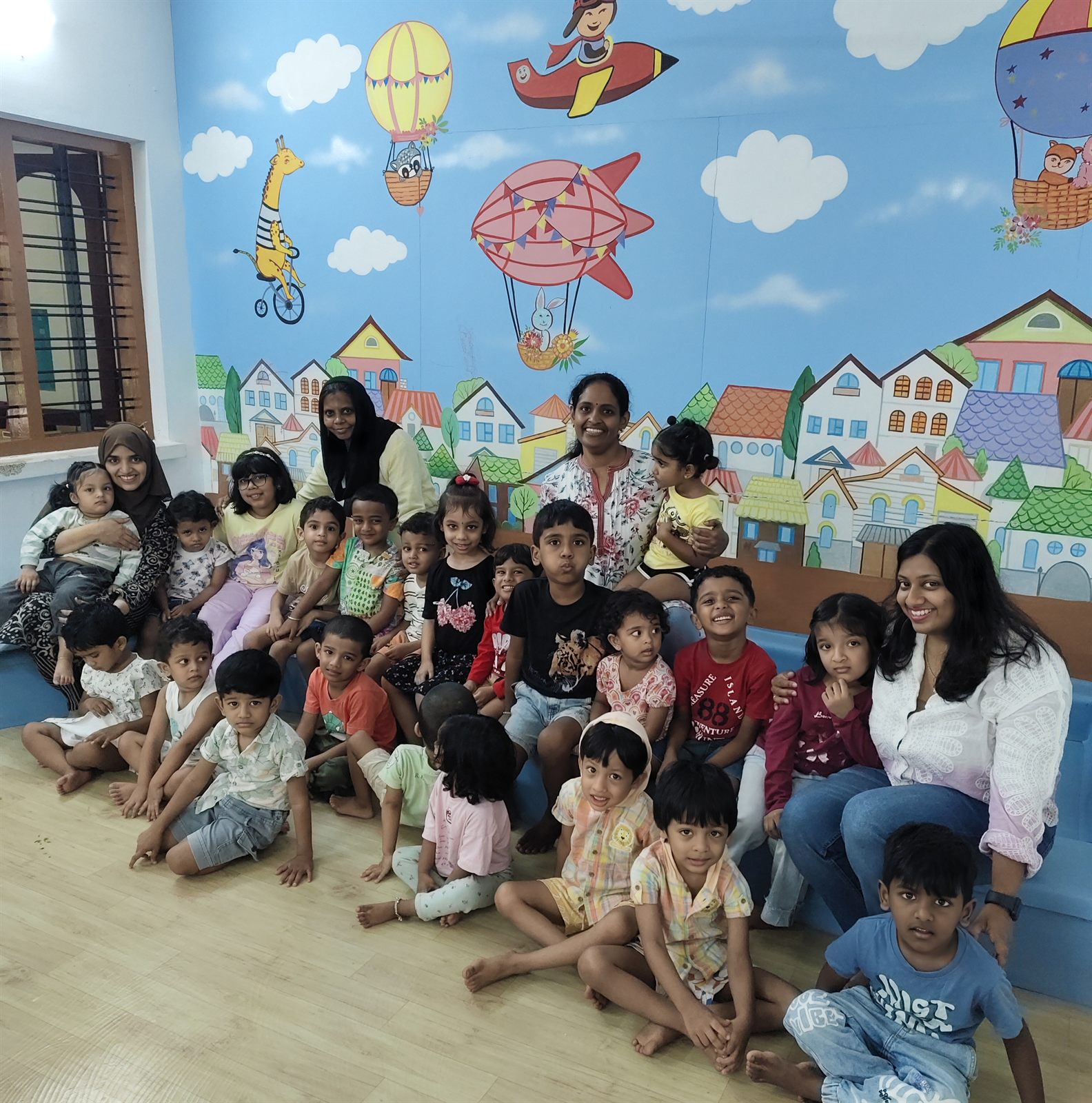 Group photo of children and teachers at The Little Graduates
