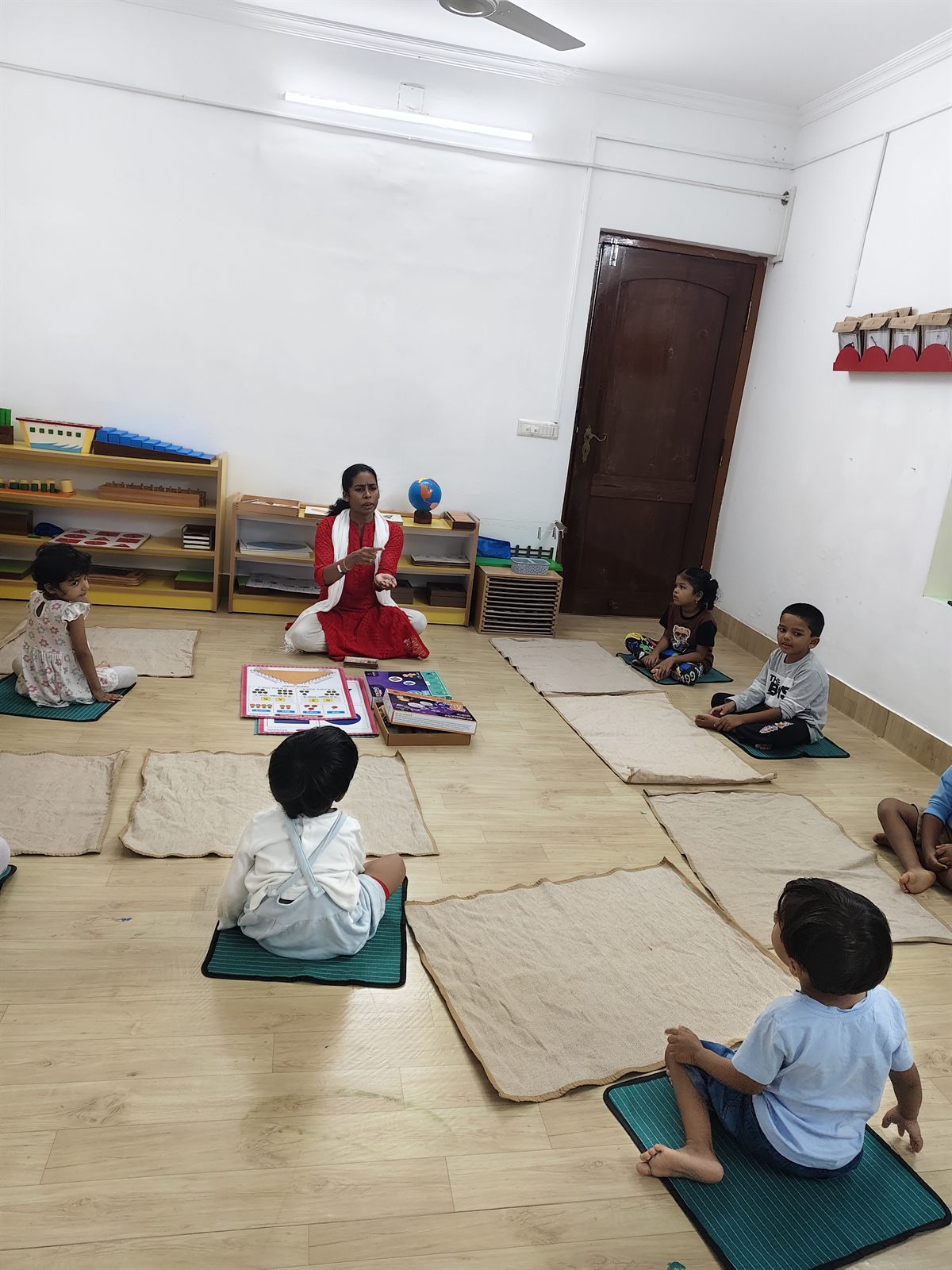 Children working on mats in a bright learning space