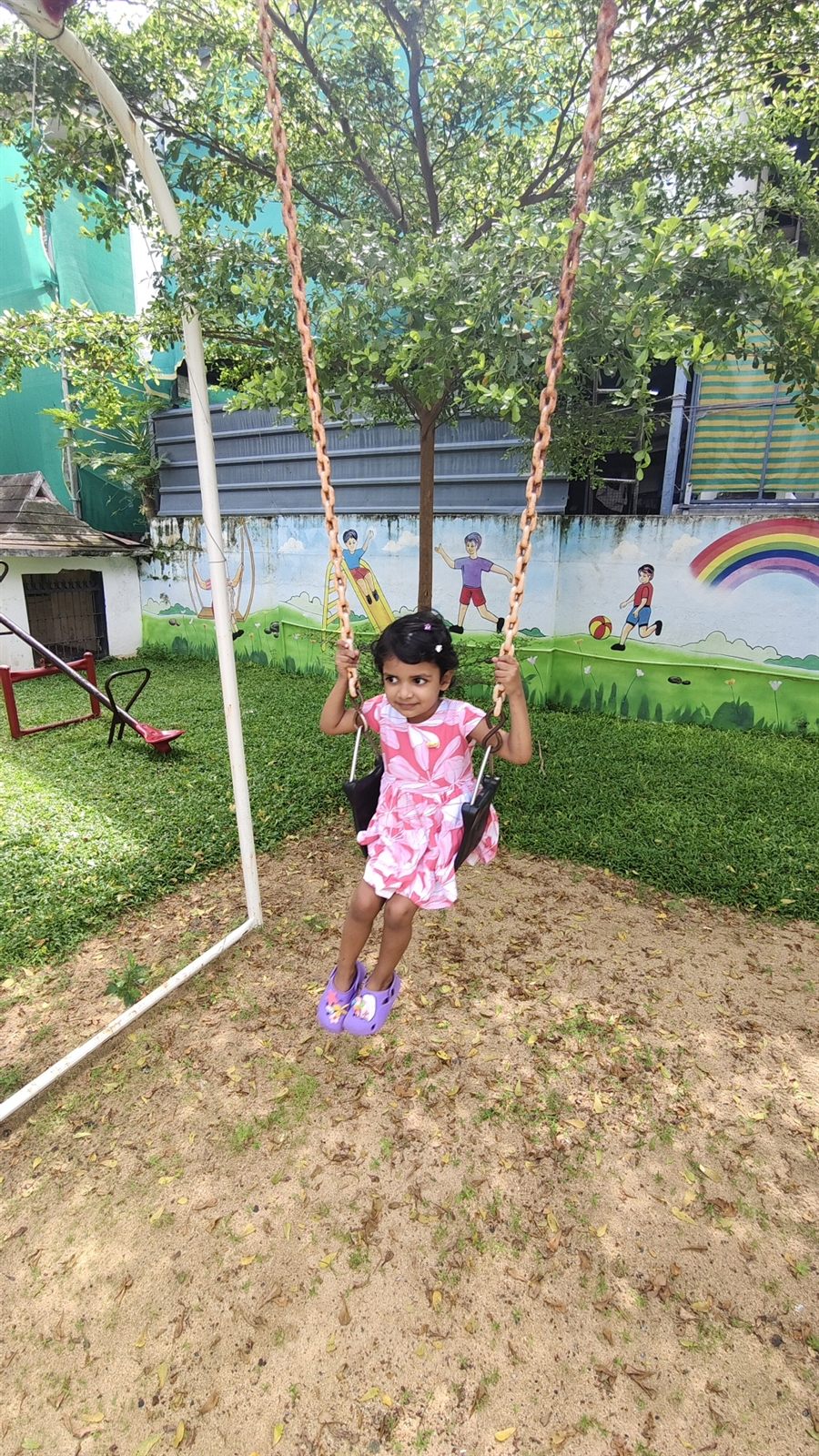 Child on a swing in the outdoor play area