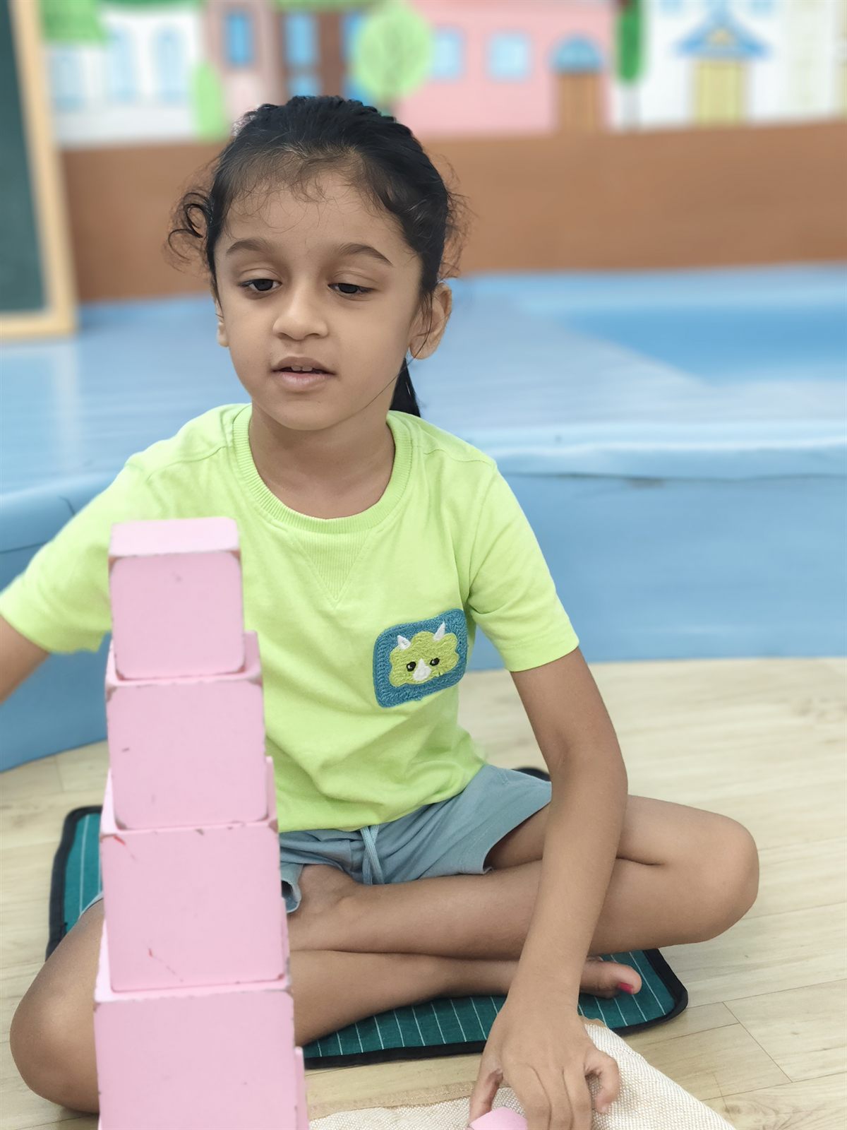 Child building the Montessori pink tower