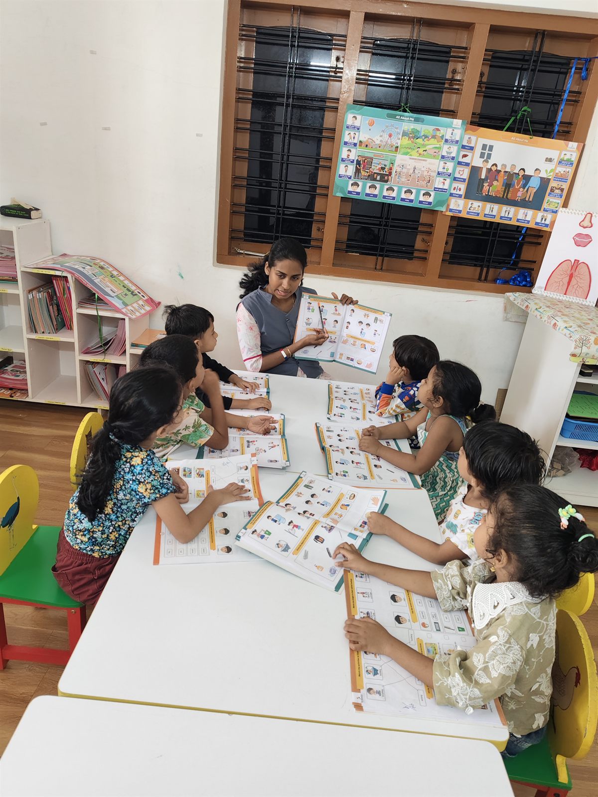 Teacher guiding children through a table activity