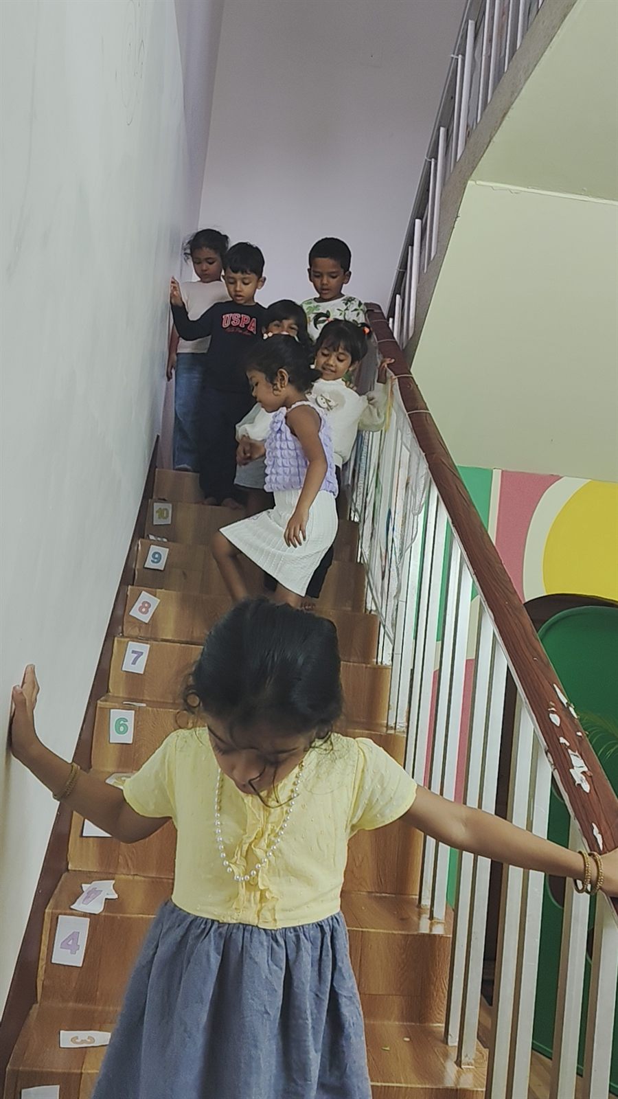 Children walking carefully on the staircase