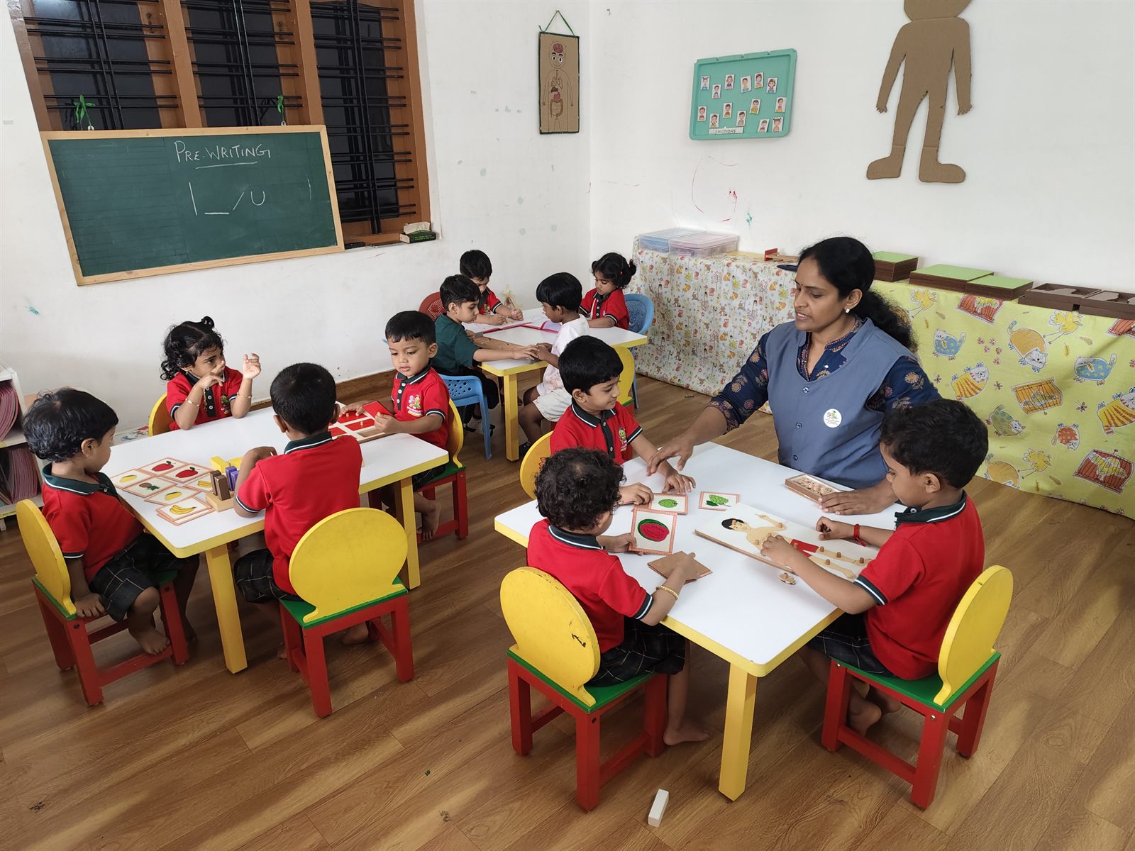 Children in a group activity with their teacher